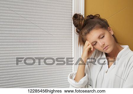 Teenage girl resting her head on her hand View Large Photo Image Stock Photograph - Teenage girl resting her head on her hand. Fotosearch