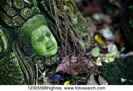 Terra-cotta sculpture of a Thai god or perhaps a temple attendant lies in ruin; Chiang Mai, Thailand View Large Photo Image Stock Photograph - Terra-cotta sculpture of a Thai god or perhaps a temple attendant lies in ruin; Chiang Mai, Thailand. Fotosearch