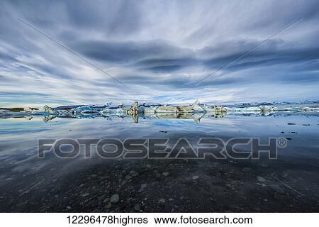 Stock Photograph - The icebergs of the ice lagoon known as Jokulsarlon along the south coast of Iceland; Iceland. Fotosearch