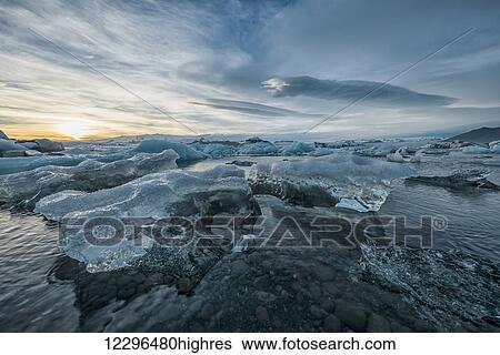 Stock Photograph - The icebergs of the ice lagoon known as Jokulsarlon along the south coast of Iceland; Iceland. Fotosearch