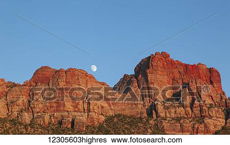 The moon rises over the red mountains near Zion; Utah, United States of America View Large Photo Image Stock Photograph - The moon rises over the red mountains near Zion; Utah, United States of America. Fotosearch