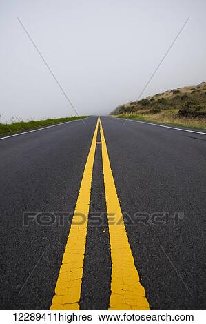 Stock Photograph - The road to Haleakala Summit fogged in at 6, 000 foot elevation; Maui, Hawaii, United States of America. Fotosearch