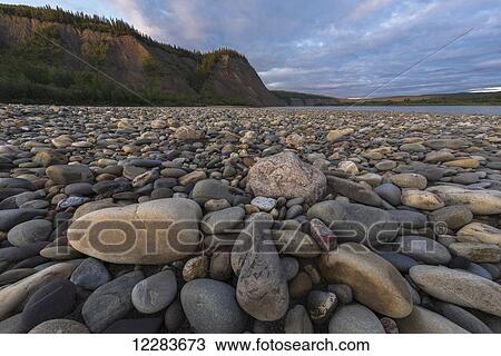 Stock Image - The rocky shoreline along the Peel River, near Taco Bar; Yukon, Canada. Fotosearch