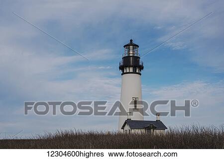 Stock Photograph - The sky clears around Yaquina Head Lighthouse, near Newport; Oregon, United States of America. Fotosearch