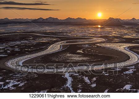 The sun sets behind the Wood River Mountains and Snake River within the Togiak National Wildlife Refuge, Alaska. View Large Photo Image Stock Photograph - The sun sets behind the Wood River Mountains and Snake River within the Togiak National Wildlife Refuge, Alaska.. Fotosearch
