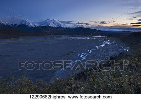 The Thorofare River winds down toward the McKinley River, while Denali towers in the twilight in Denali National Park & Preserve, Alaska, in autumn. View Large Photo Image Stock Photograph - The Thorofare River winds down toward the McKinley River, while Denali towers in the twilight in Denali National Park & Preserve, Alaska, in autumn.. Fotosearch