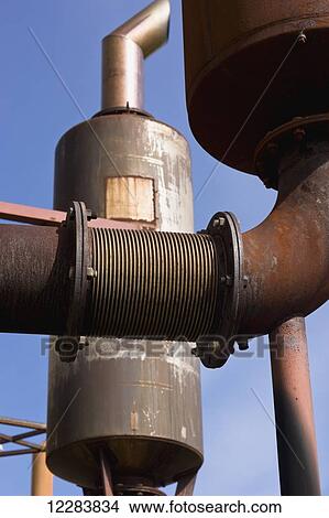 Picture - Threaded pipe fittings connecting rusty pipe outside an electrical power plant, Sand Point, Southwestern Alaska, USA, Summer. Fotosearch