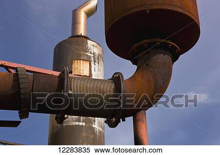 Stock Photography - Threaded pipe fittings connecting rusty pipe outside an electrical power plant, Sand Point, Southwestern Alaska, USA, Summer. Fotosearch