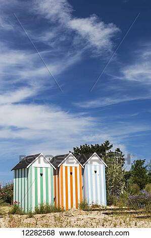 Three colourful striped painted outhouses on a sandy grassy hill with trees; Roscoff, Brittany, France View Large Photo Image Stock Photo - Three colourful striped painted outhouses on a sandy grassy hill with trees; Roscoff, Brittany, France. Fotosearch
