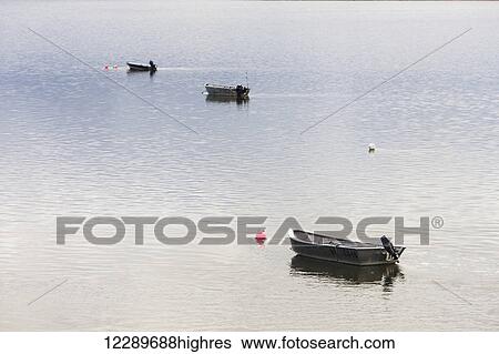 Three skiffs, used by commercial salmon fishing setnetters, sit at anchor in calm water in the Naknek River, Bristol Bay, Southwestern Alaska, Summer, USA View Large Photo Image Stock Photograph - Three skiffs, used by commercial salmon fishing setnetters, sit at anchor in calm water in the Naknek River, Bristol Bay, Southwestern Alaska, Summer, USA. Fotosearch