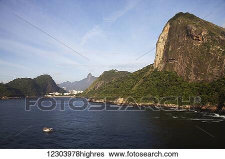 Stock Photograph - Tiburcio Beach, Christ the Redeemer statue and Sugarloaf Mountain; Rio de Janeiro, Brazil. Fotosearch