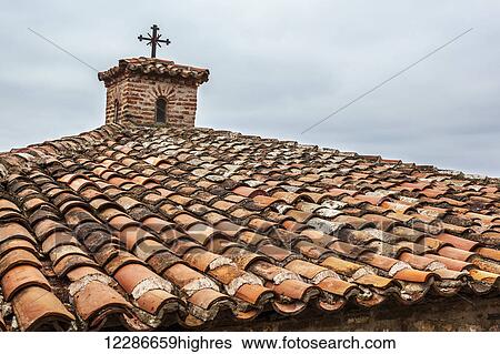 Stock Photograph - Tiles and cross on roof of Monastery Varlaam; Meteora, Greece. Fotosearch