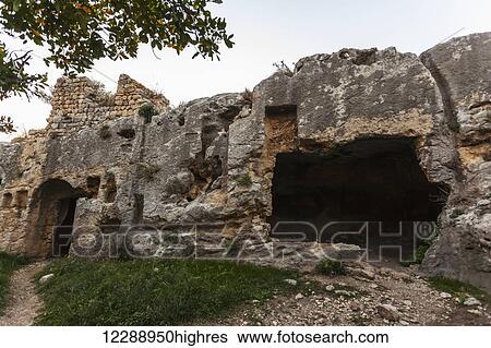 Stock Photograph - Titus' Tunnel cuts through the solid rock of the mountain in two places to provide a water channel to prevent flooding; Cevlik, Turkey. Fotosearch