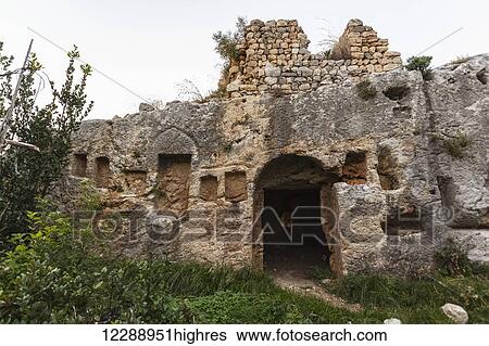 Stock Photograph - Titus' Tunnel cuts through the solid rock of the mountain in two places to provide a water channel to prevent flooding; Cevlik, Turkey. Fotosearch