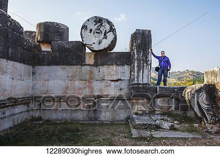 Stock Photograph - Tourist posing at the Temple of Artemis; Sardis, Turkey. Fotosearch