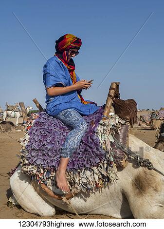 Tourist ready for a beach camel trek; Essaouira, Morocco View Large Photo Image Stock Photograph - Tourist ready for a beach camel trek; Essaouira, Morocco. Fotosearch