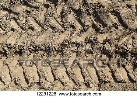 Stock Photo - Tractor tire treadmarks in soil on headland in arable field; United Kingdom. Fotosearch