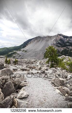Trails among the ruins of the Frank Slide site, Turtle Mountain in the background; Alberta, Canada View Large Photo Image Stock Photograph - Trails among the ruins of the Frank Slide site, Turtle Mountain in the background; Alberta, Canada. Fotosearch