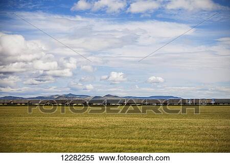 Stock Photography - Train hauling goods across the plains in Southern Alberta; Alberta, Canada. Fotosearch