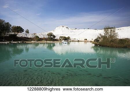 Turquoise water in a pool reflecting a white wall of mineral deposits; Pamukkale, Turkey View Large Photo Image Stock Photograph - Turquoise water in a pool reflecting a white wall of mineral deposits; Pamukkale, Turkey. Fotosearch