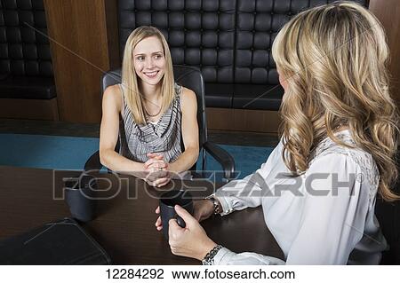 Two professional business women meeting in a boardroom; St. Albert, Alberta, Canada View Large Photo Image Stock Image - Two professional business women meeting in a boardroom; St. Albert, Alberta, Canada. Fotosearch