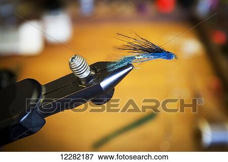 Stock Photo - Tying flies; Chilliwack, British Columbia, Canada. Fotosearch