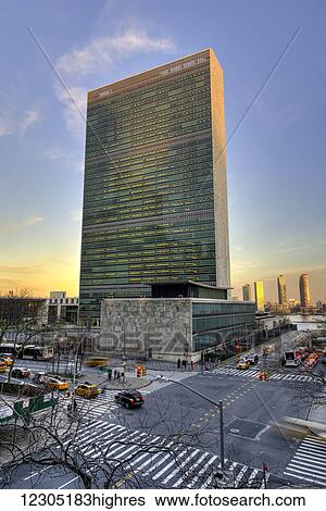 Stock Photograph - United Nations at sunset; New York City, New York, United States of America. Fotosearch