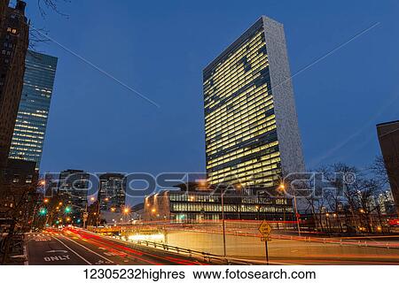 Stock Photograph - United Nations at twilight; New York City, New York, United States of America. Fotosearch