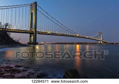 Stock Image - Verazzano-Narrows Bridge at sunset, Fort Wadsworth; Staten Island, New York, United States of America. Fotosearch