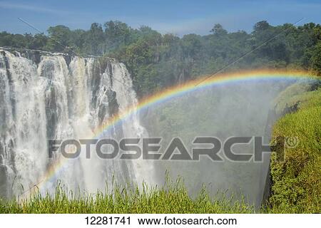 Stock Image - Victoria Falls with rainbow; Livingstone, Zambia. Fotosearch
