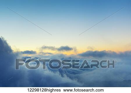 Stock Photograph - View Above the Clouds, Beautiful Sunset Cloudscape. Fotosearch