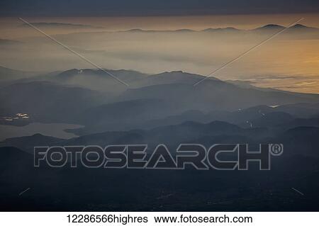 View of mountains and clouds at sunset along the coastline; Greece View Large Photo Image Stock Photograph - View of mountains and clouds at sunset along the coastline; Greece. Fotosearch