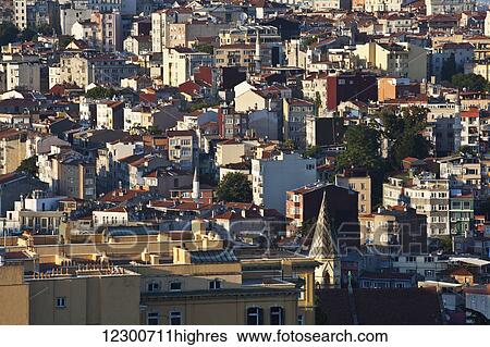 Stock Photograph - View of rooftops in the Beyoglu district of Istanbul during golden hour; Istanbul, Turkey. Fotosearch