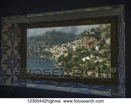 Stock Photograph - View out a tile trimmed window of the coastline; Amalfi, Italy. Fotosearch