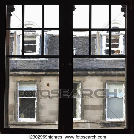 Stock Photograph - View out a window to a residential building where the lines of the architectural detail are blurred; Edinburgh, Scotland. Fotosearch