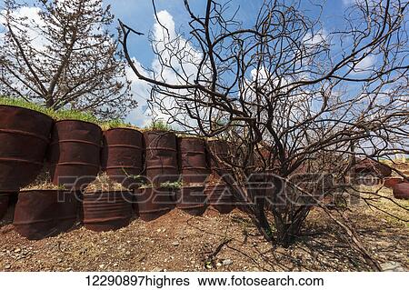 Wall of rusty metal barrels at the site of an old Syrian army bunker; Golan Heights, Israel View Large Photo Image Stock Photograph - Wall of rusty metal barrels at the site of an old Syrian army bunker; Golan Heights, Israel. Fotosearch