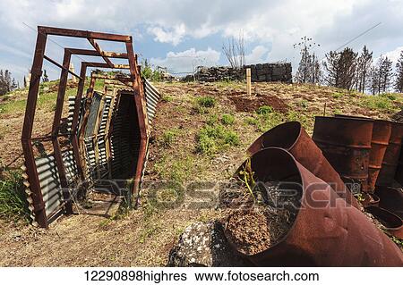 Stock Photograph - Wall of rusty metal barrels at the site of an old Syrian army bunker; Golan Heights, Israel. Fotosearch
