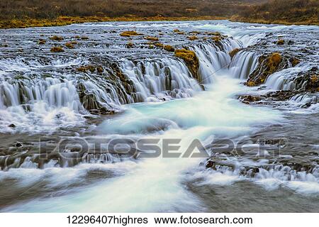 Water cascading over rocks and flowing into a river; Bruarfoss, Iceland View Large Photo Image Stock Photograph - Water cascading over rocks and flowing into a river; Bruarfoss, Iceland. Fotosearch