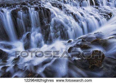 Stock Photograph - Water cascading over rugged rocks, Bruarfoss; Iceland. Fotosearch