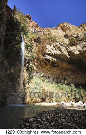 Water flowing out of a rock cliff; Israel View Large Photo Image Stock Photograph - Water flowing out of a rock cliff; Israel. Fotosearch