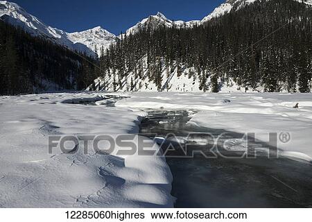 Water flowing under melting snow and the Canadian Rocky Mountains, Yoho National Park; Field, British Columbia, Canada View Large Photo Image Stock Photograph - Water flowing under melting snow and the Canadian Rocky Mountains, Yoho National Park; Field, British Columbia, Canada. Fotosearch