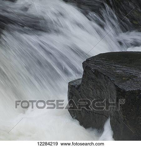 Water rushing over rocks in a river; Kenora, Ontario, Canada View Large Photo Image Stock Photo - Water rushing over rocks in a river; Kenora, Ontario, Canada. Fotosearch
