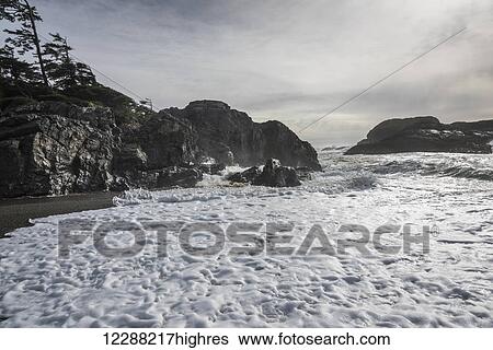 Water washes onto the shore with rugged, rocky cliffs; Tofino, British Columbia, Canada View Large Photo Image Stock Photograph - Water washes onto the shore with rugged, rocky cliffs; Tofino, British Columbia, Canada. Fotosearch