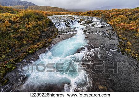 Waterfall and flowing water in a river; Bruarfoss, Iceland View Large Photo Image Stock Photograph - Waterfall and flowing water in a river; Bruarfoss, Iceland. Fotosearch
