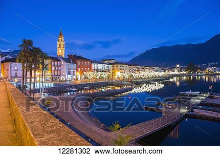Stock Image - Waterfront of Lake Maggiore at dusk; Ascona, Ticino, Switzerland. Fotosearch