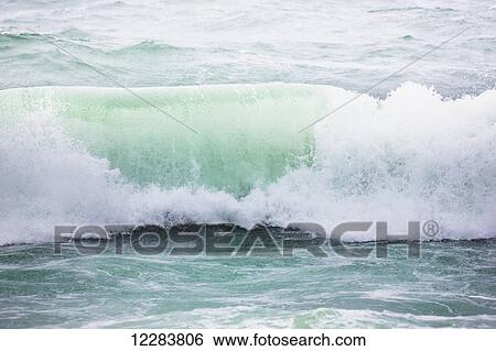 Stock Photograph - Wave breaking on the shore of St. Paul Island, Bering Sea, Southwestern Alaska, USA, Summer. Fotosearch