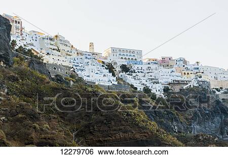 Stock Photograph - Whitewash buildings on a hillside on a greek island; Santorini, Greece. Fotosearch