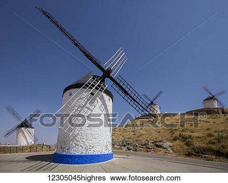 Stock Photograph - Windmills against a blue sky; Consuegra, Spain. Fotosearch