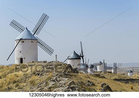 Windmills in a row against a blue sky; Consuegra, Spain View Large Photo Image Stock Photograph - Windmills in a row against a blue sky; Consuegra, Spain. Fotosearch