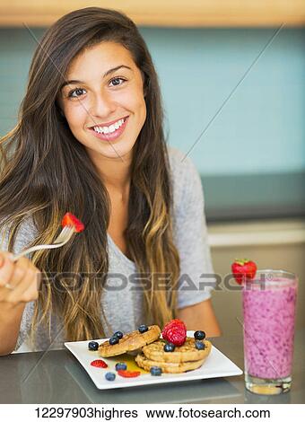 Woman Eating Waffles with Fresh Fruit for Breakfast View Large Photo Image Stock Photograph - Woman Eating Waffles with Fresh Fruit for Breakfast. Fotosearch